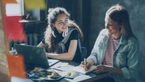Talk money week 2026: two women talking at a desk
