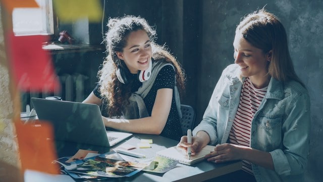 Talk money week 2026: two women talking at a desk